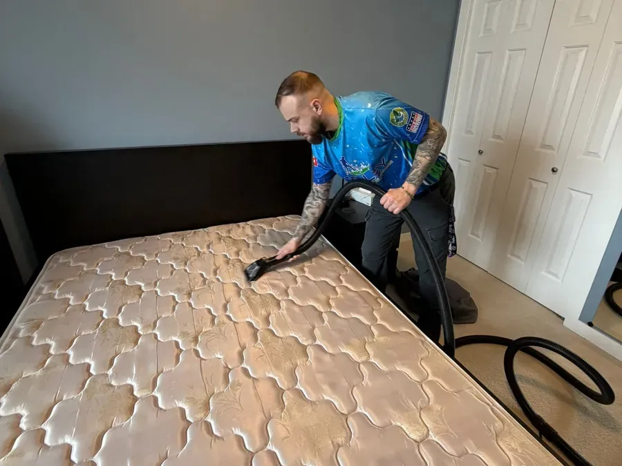 Valley Fresh technician deep-cleaning a mattress in an Abbotsford bedroom