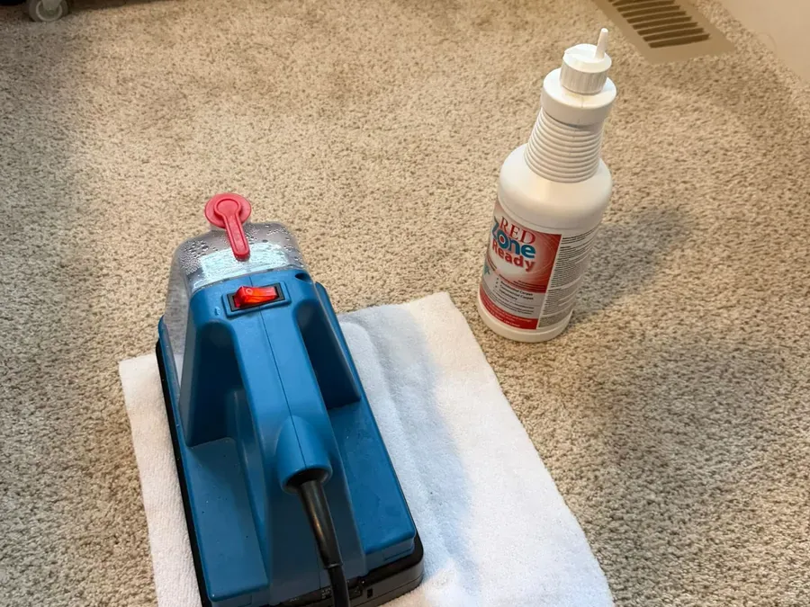 Spot treatment with heat transfer machine and Red Zone solution on carpet
